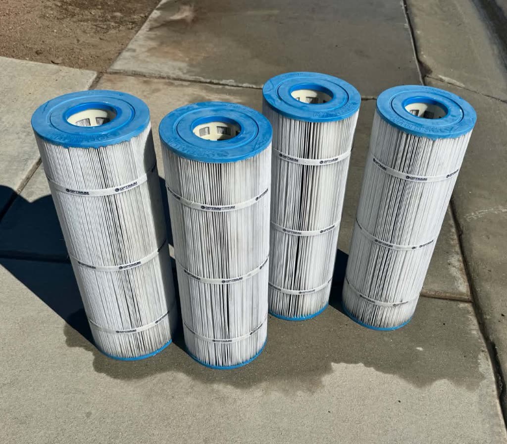 Pool filter cartridges after cleaning, pleats white and fully open.